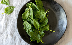 plate full of baby spinach leaves