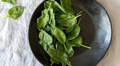 plate full of baby spinach leaves