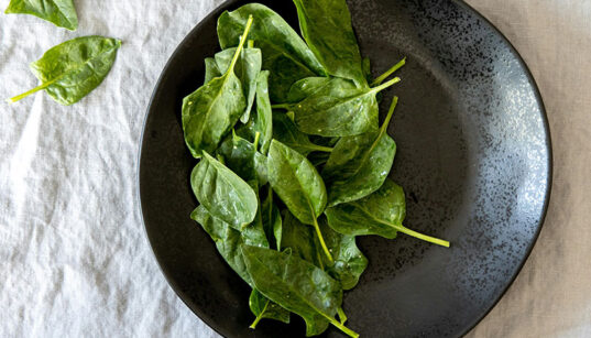 plate full of baby spinach leaves