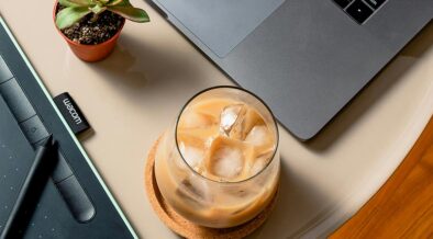 iced coffee on a table near a laptop