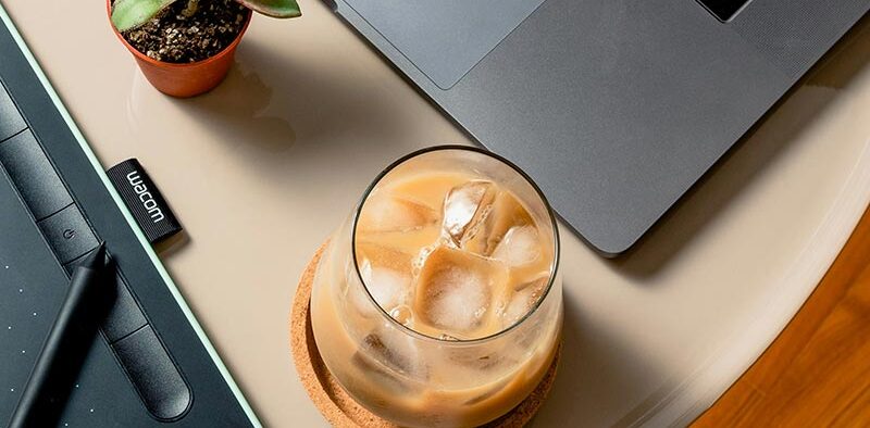 iced coffee on a table near a laptop