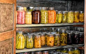 cans and jars of preserved produce on shelves