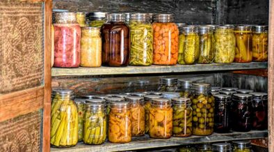 cans and jars of preserved produce on shelves
